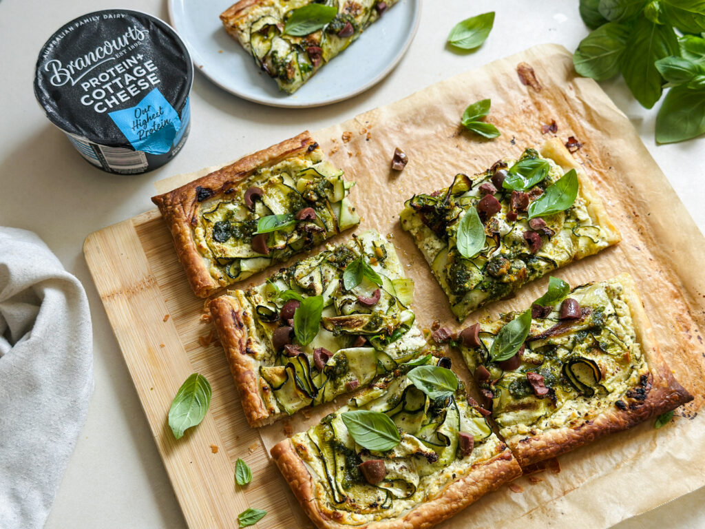 Zucchini Tarts being sliced with protein cottage cheese.