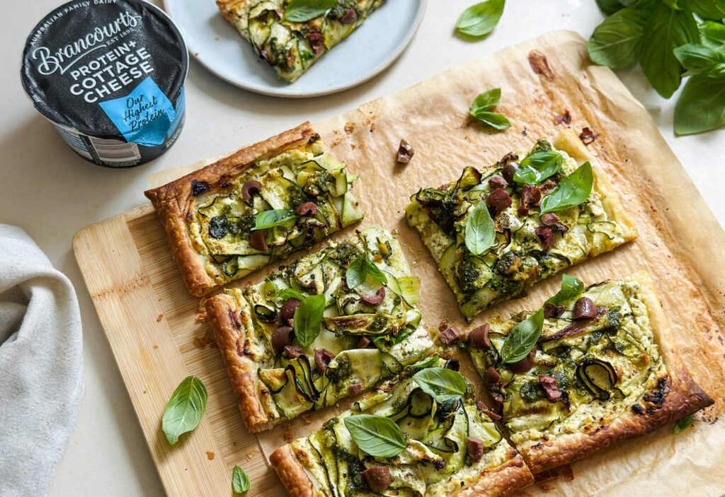 Zucchini Tarts being sliced with protein cottage cheese.